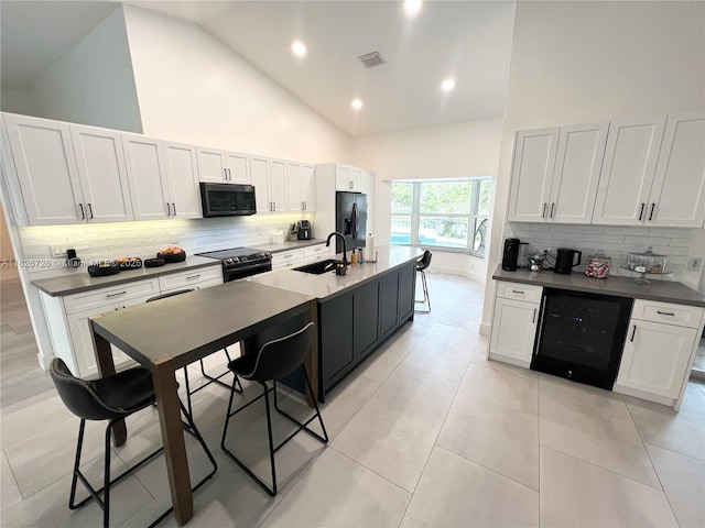 1732 SW 103rd Ln, Davie, FL 33324 - kitchen featuring black appliances, beverage cooler, high vaulted ceiling, tasteful backsplash, and dark countertops