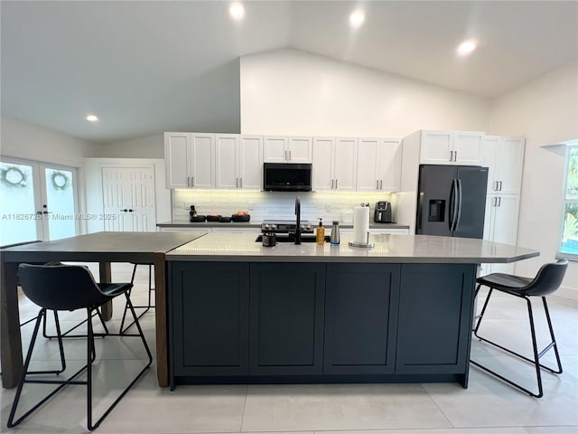1732 SW 103rd Ln, Davie, FL 33324 - kitchen featuring fridge with ice dispenser, black microwave, white cabinets, tasteful backsplash, and recessed lighting