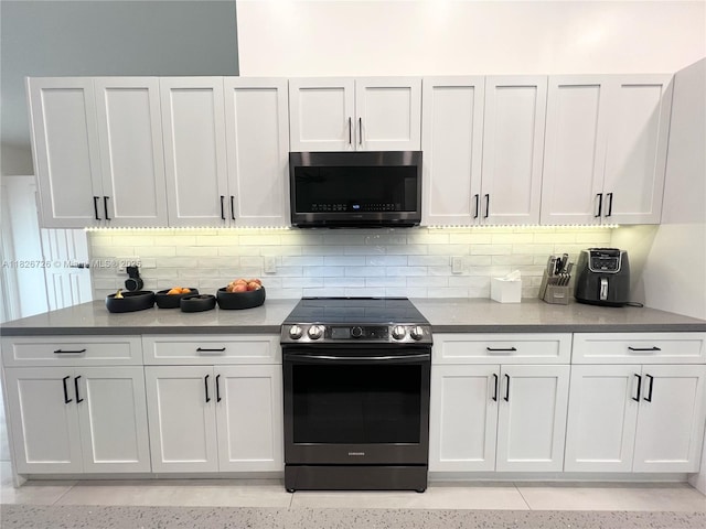 1732 SW 103rd Ln, Davie, FL 33324 - kitchen featuring stainless steel electric range oven, decorative backsplash, and white cabinetry