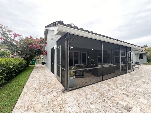 1732 SW 103rd Ln, Davie, FL 33324 - rear view of house with a patio area, an outdoor hangout area, and a sunroom