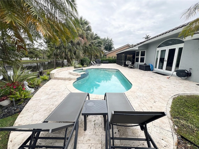 1732 SW 103rd Ln, Davie, FL 33324 - view of pool with french doors, a patio area, a pool with connected hot tub, and a water view