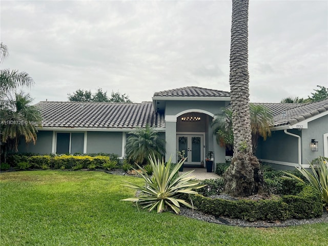 1732 SW 103rd Ln, Davie, FL 33324 - view of front of home with french doors, a tiled roof, a front lawn, and stucco siding