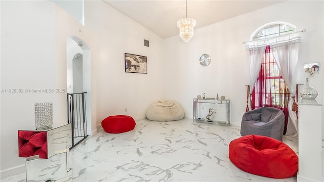 1720 SW 137th Way, Miramar, FL 33027 - sitting room with marble finish flooring, arched walkways, high vaulted ceiling, and a chandelier