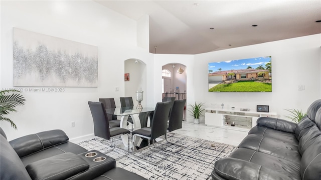 1720 SW 137th Way, Miramar, FL 33027 - living area featuring arched walkways, marble look tile flooring, and vaulted ceiling