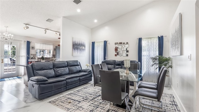1720 SW 137th Way, Miramar, FL 33027 - living area with rail lighting, a chandelier, light marble finish flooring, and a high ceiling