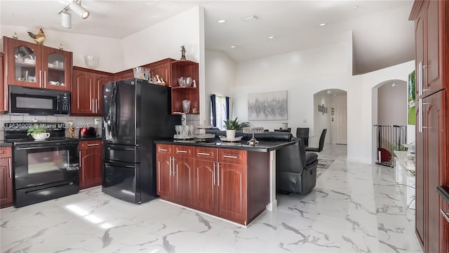 1720 SW 137th Way, Miramar, FL 33027 - kitchen with black appliances, arched walkways, dark brown cabinets, dark countertops, and a high ceiling
