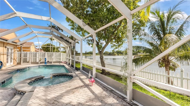 1720 SW 137th Way, Miramar, FL 33027 - view of swimming pool with a water view, glass enclosure, a pool with connected hot tub, and a patio area