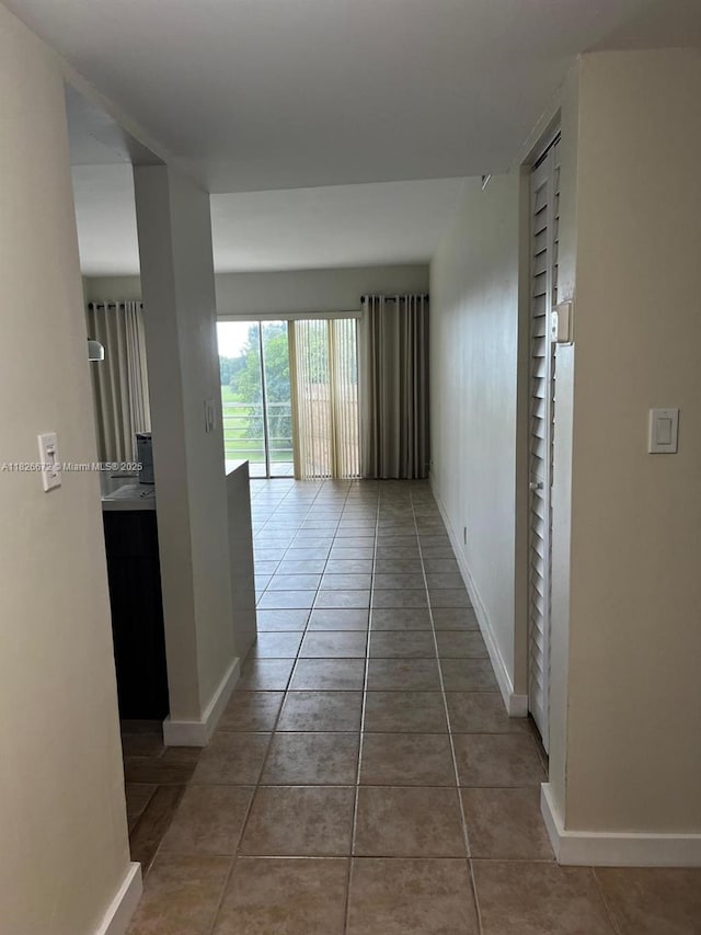 5100 SW 90th Ave Unit 406, Cooper City, FL 33328 - corridor featuring tile patterned flooring and baseboards