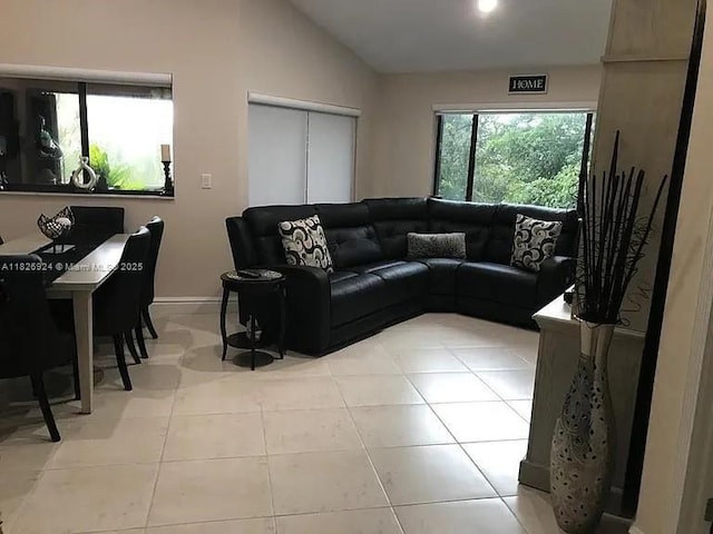 15405 N Miami Lakeway N Unit 307, Miami Lakes, FL 33014 - living room featuring vaulted ceiling and tile patterned flooring