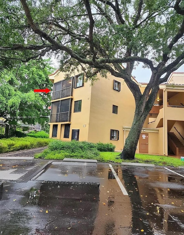 15405 N Miami Lakeway N Unit 307, Miami Lakes, FL 33014 - view of property featuring uncovered parking and stairs