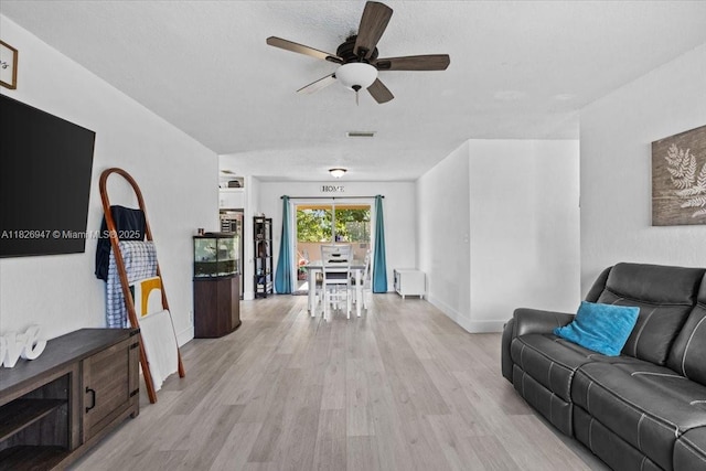 7307 SW 8th St, North Lauderdale, FL 33068 - living room with light wood-style floors, a ceiling fan, and a textured ceiling