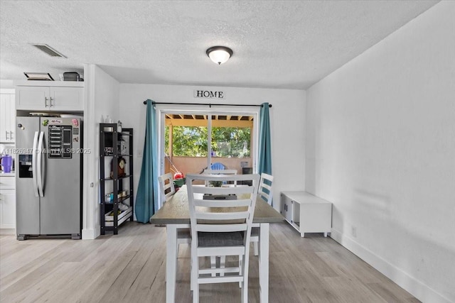 7307 SW 8th St, North Lauderdale, FL 33068 - dining area with a textured ceiling and light wood-style flooring