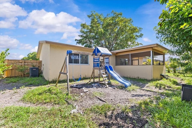 7307 SW 8th St, North Lauderdale, FL 33068 - rear view of house featuring a playground and stucco siding