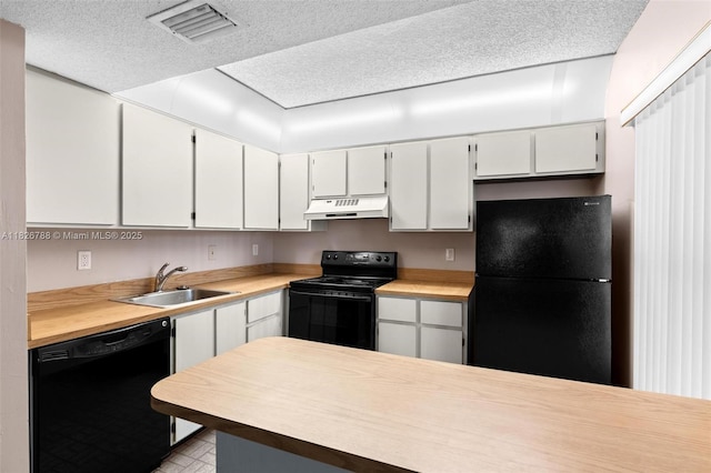 9852 NW 3rd Ct Unit 1, Plantation, FL 33324 - kitchen with black appliances, under cabinet range hood, light countertops, white cabinets, and a textured ceiling