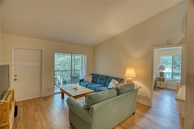 6286 Chasewood Dr Unit G, Jupiter, FL 33458 - living area with healthy amount of natural light, vaulted ceiling, light wood finished floors, and a textured ceiling