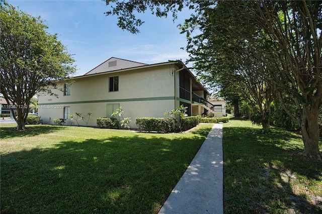 6286 Chasewood Dr Unit G, Jupiter, FL 33458 - view of side of home with a yard and stucco siding