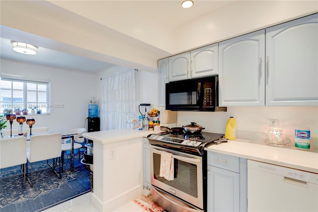 13645 NW 3rd Ave, North Miami, FL 33168 - kitchen featuring black microwave, stainless steel range with electric cooktop, dishwasher, a peninsula, and light countertops