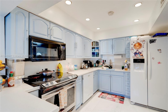 13645 NW 3rd Ave, North Miami, FL 33168 - kitchen featuring white appliances, light countertops, recessed lighting, blue cabinetry, and glass insert cabinets