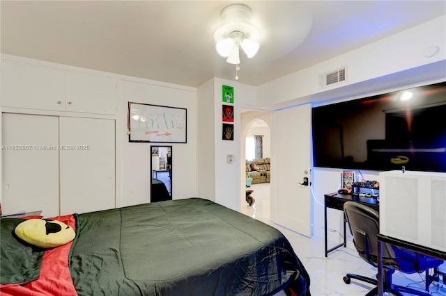 13645 NW 3rd Ave, North Miami, FL 33168 - bedroom featuring arched walkways, light marble finish flooring, a closet, and a desk