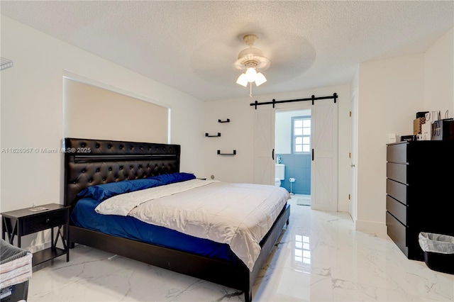 13645 NW 3rd Ave, North Miami, FL 33168 - bedroom with marble tiled floors, a barn door, a textured ceiling, a ceiling fan, and connected bathroom