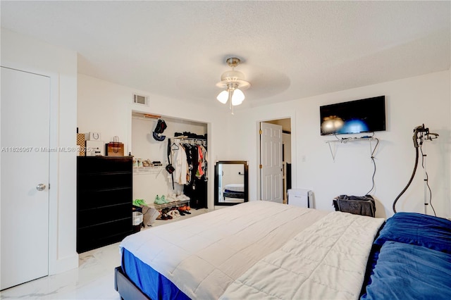 13645 NW 3rd Ave, North Miami, FL 33168 - bedroom with light marble finish floors, a closet, and a ceiling fan