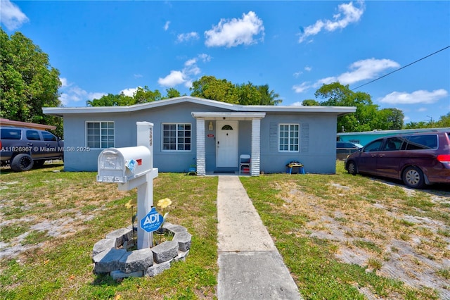 13645 NW 3rd Ave, North Miami, FL 33168 - bungalow-style home featuring stucco siding and a front yard