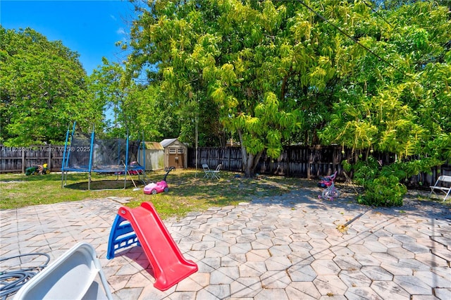 13645 NW 3rd Ave, North Miami, FL 33168 - fenced backyard featuring a storage unit, a patio, and a trampoline