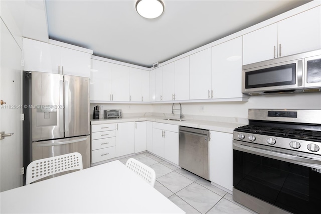 2030 S Ocean Dr Unit 227, Hallandale Beach, FL 33009 - kitchen with appliances with stainless steel finishes, light countertops, white cabinets, and light tile patterned flooring