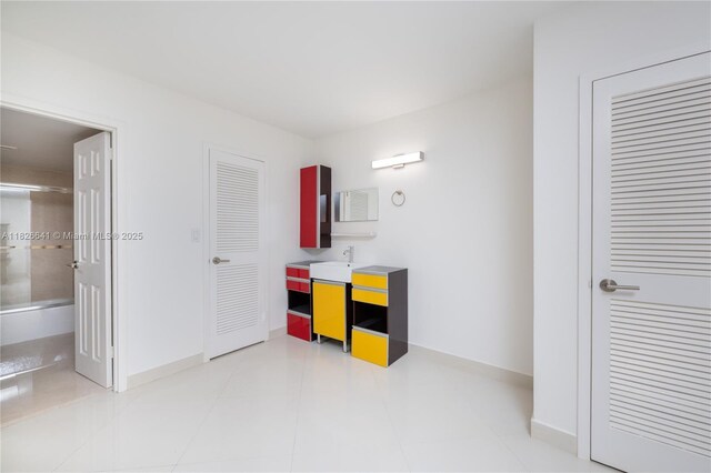 2030 S Ocean Dr Unit 227, Hallandale Beach, FL 33009 - unfurnished bedroom featuring baseboards and connected bathroom