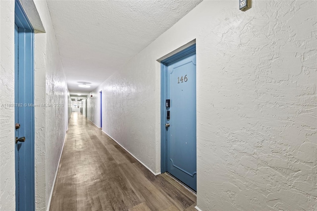 1428 SE 4th Ave Unit 146, Deerfield Beach, FL 33441 - hall with a textured wall, dark wood-type flooring, and a textured ceiling