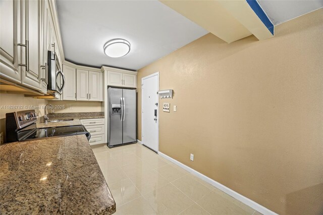 1428 SE 4th Ave Unit 146, Deerfield Beach, FL 33441 - kitchen featuring appliances with stainless steel finishes, dark stone countertops, and light tile patterned floors