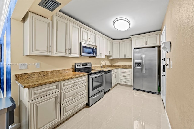 1428 SE 4th Ave Unit 146, Deerfield Beach, FL 33441 - kitchen with appliances with stainless steel finishes, light tile patterned flooring, and light stone counters
