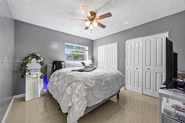 1428 SE 4th Ave Unit 146, Deerfield Beach, FL 33441 - bedroom with two closets, a textured ceiling, light tile patterned floors, and a ceiling fan
