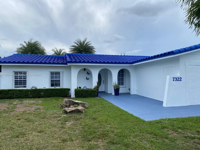 7322 SW 134th Pl, Miami, FL 33183 - view of front of home with a front lawn, a tile roof, and stucco siding