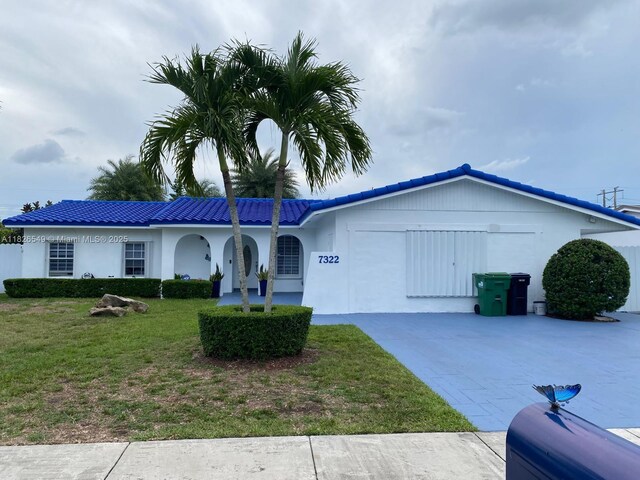 7322 SW 134th Pl, Miami, FL 33183 - single story home featuring an attached garage, driveway, a front lawn, and stucco siding