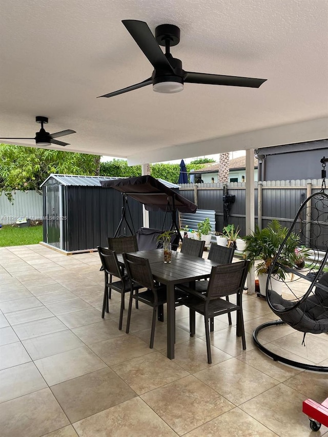 7322 SW 134th Pl, Miami, FL 33183 - fenced backyard featuring outdoor dining area, a ceiling fan, and a patio