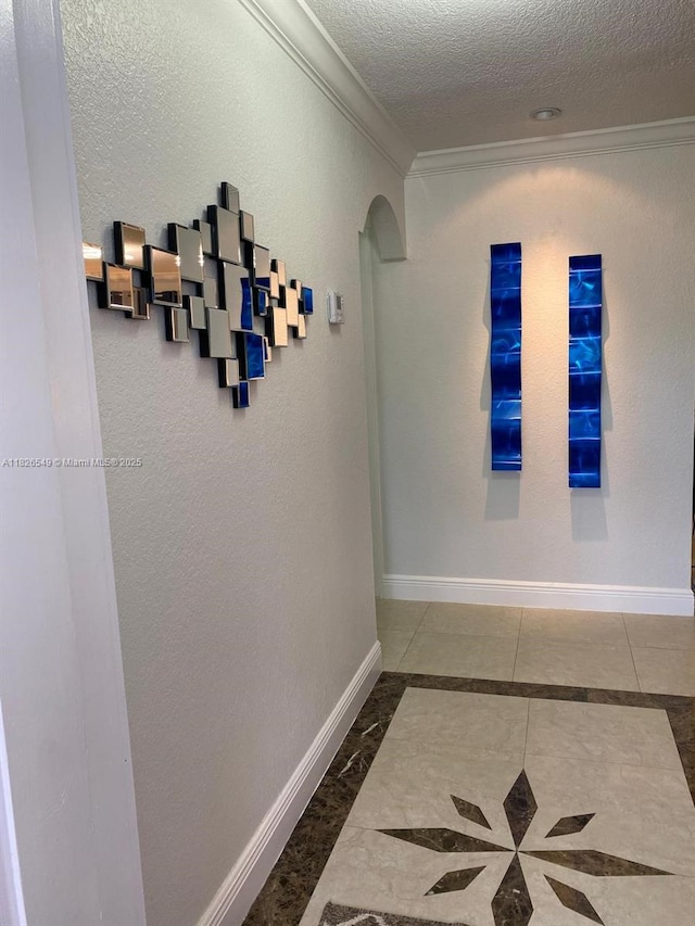 7322 SW 134th Pl, Miami, FL 33183 - hall featuring ornamental molding, arched walkways, a textured ceiling, inlaid floor details, and a textured wall
