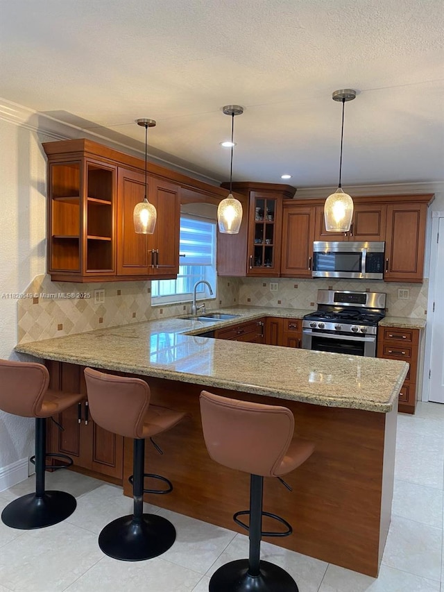 7322 SW 134th Pl, Miami, FL 33183 - kitchen featuring stainless steel appliances, a peninsula, light stone counters, glass insert cabinets, and brown cabinets