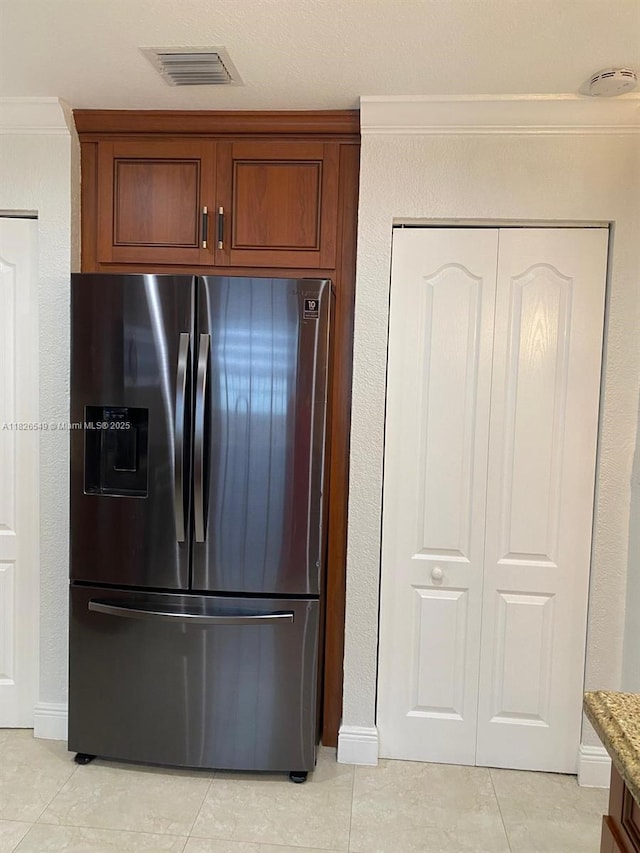 7322 SW 134th Pl, Miami, FL 33183 - kitchen with stainless steel fridge with ice dispenser, light tile patterned flooring, and brown cabinets