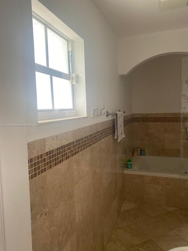 7322 SW 134th Pl, Miami, FL 33183 - full bath with a relaxing tiled tub, tiled shower, tile walls, and wainscoting