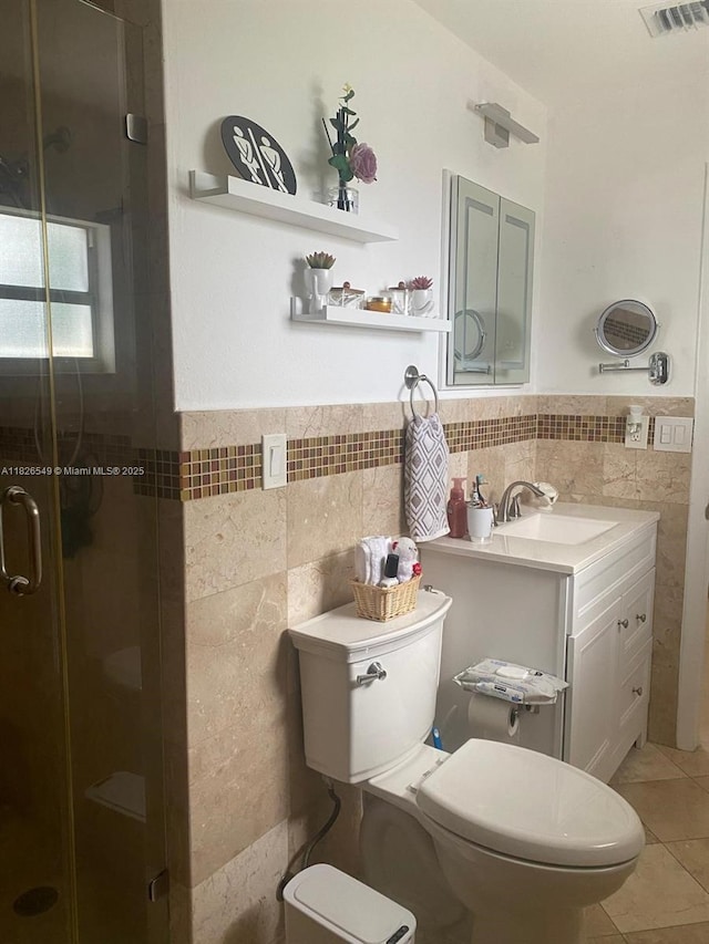 7322 SW 134th Pl, Miami, FL 33183 - full bathroom featuring tile walls, vanity, a shower stall, tile patterned floors, and wainscoting