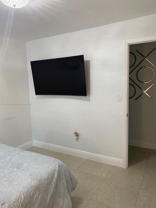 7322 SW 134th Pl, Miami, FL 33183 - bedroom featuring baseboards and light tile patterned floors