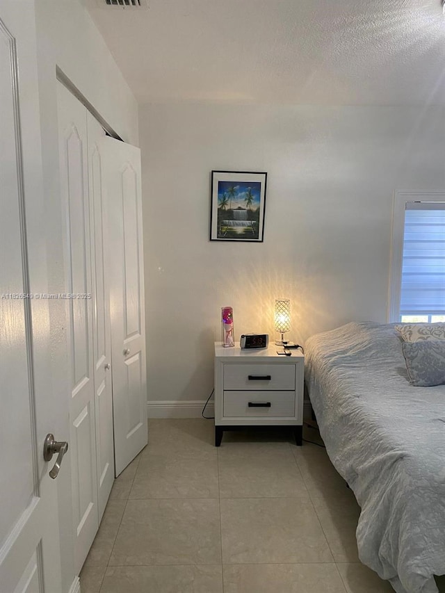 7322 SW 134th Pl, Miami, FL 33183 - bedroom with light tile patterned floors and a closet