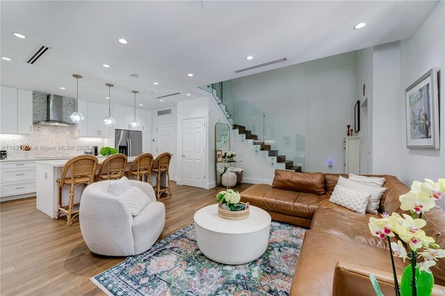 888 S Douglas Rd Unit 115, Coral Gables, FL 33134 - living area with light wood-style flooring, stairway, and recessed lighting