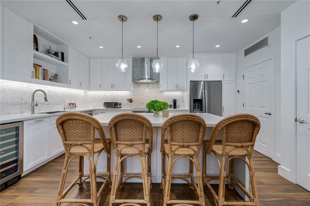888 S Douglas Rd Unit 115, Coral Gables, FL 33134 - kitchen with stainless steel fridge, wall chimney exhaust hood, wine cooler, and light countertops