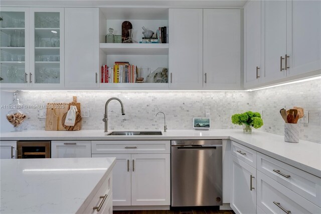888 S Douglas Rd Unit 115, Coral Gables, FL 33134 - kitchen with stainless steel dishwasher, white cabinets, tasteful backsplash, open shelves, and glass insert cabinets