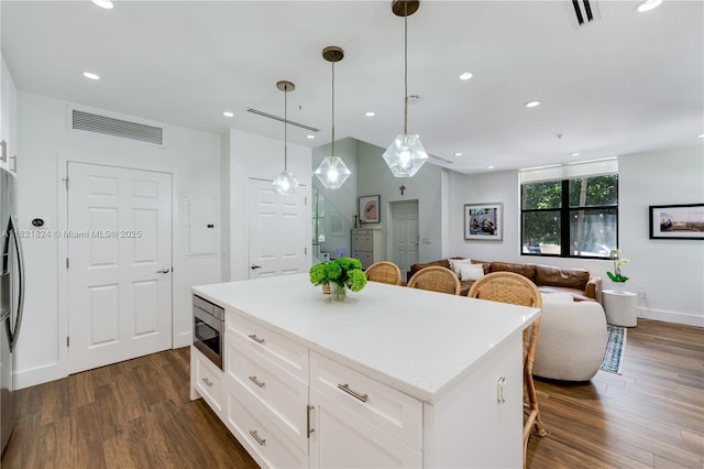 888 S Douglas Rd Unit 115, Coral Gables, FL 33134 - kitchen featuring stainless steel appliances, a breakfast bar area, dark wood-type flooring, open floor plan, and recessed lighting