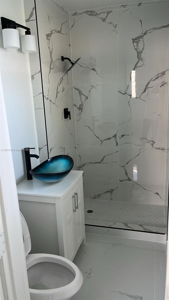 1301 NW 198th St, Miami Gardens, FL 33169 - bathroom featuring a marble finish shower and marble finish flooring