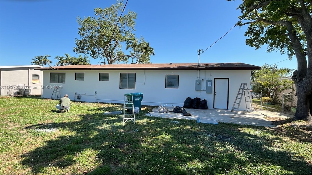 1301 NW 198th St, Miami Gardens, FL 33169 - back of property featuring a yard, a patio area, and stucco siding