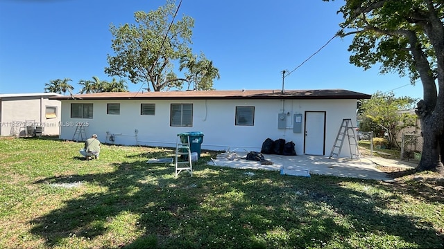 1301 NW 198th St, Miami Gardens, FL 33169 - back of property featuring a yard, a patio area, and stucco siding